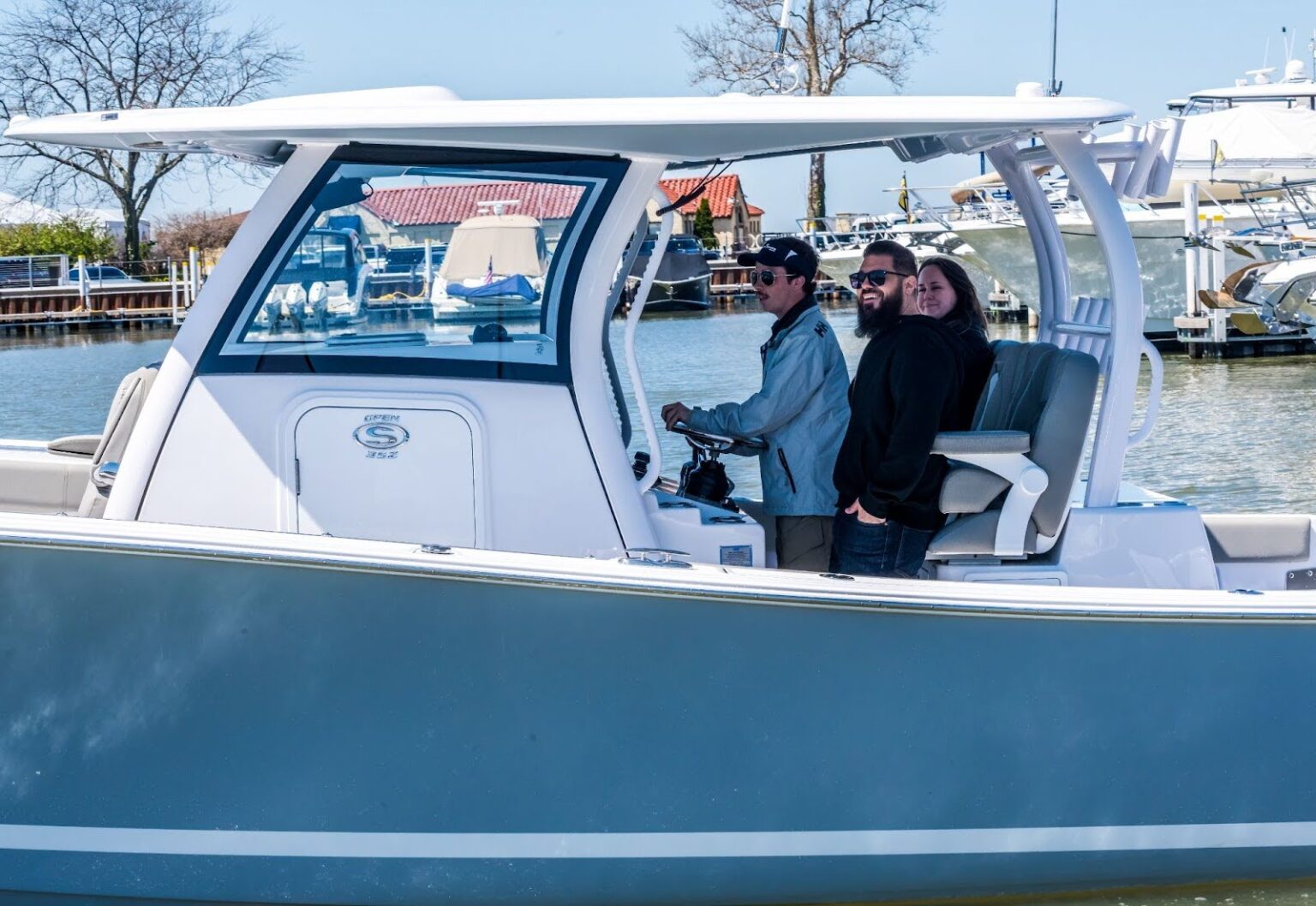 Boat show visitor test-driving a boat — the on-water experience at North Coast Harbor
